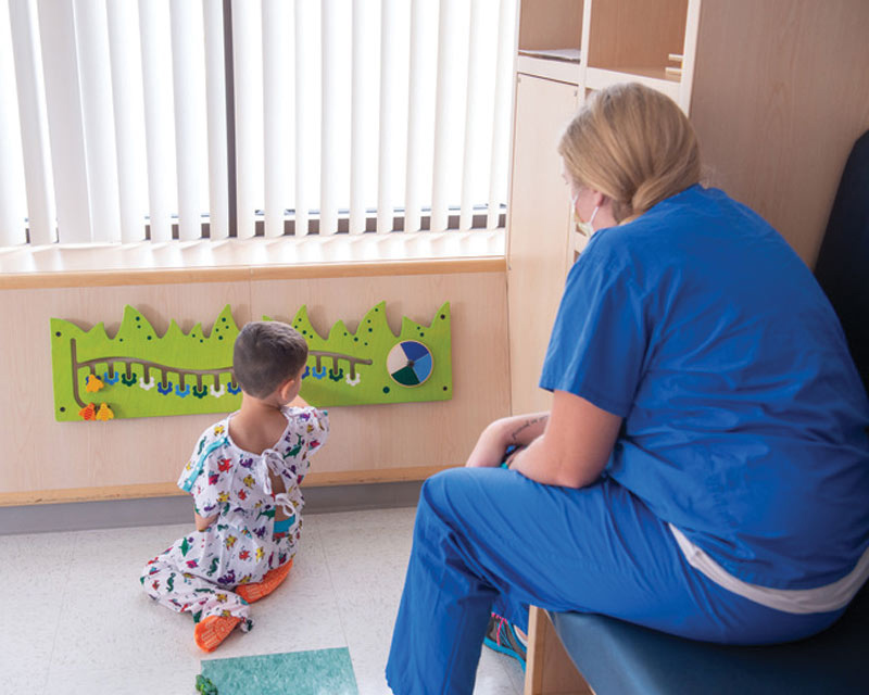 Female nurse observing pediatric patient