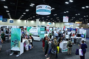 A crowd of people are gathered at the AORN Central booth at AORN Expo