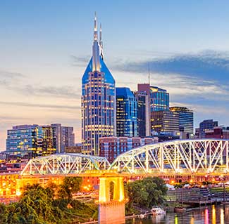 Downtown Nashville at night with bridge lights on.