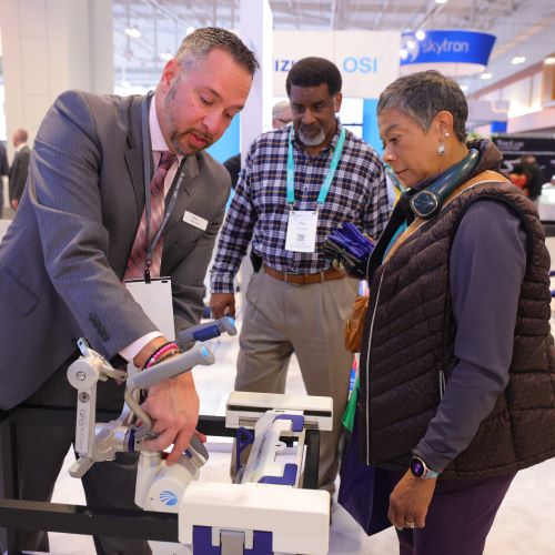 Expo attendees watching exhibitor demo