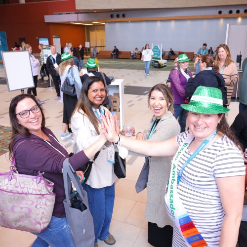 Expo attendees giving high-fives