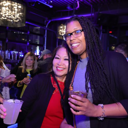 Two women embrace at Foundation party