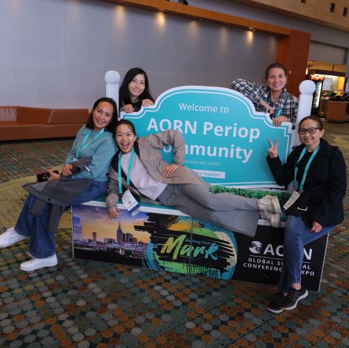 Expo attendees pose in front of sign