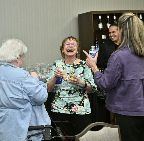 Three women laugh at Expo